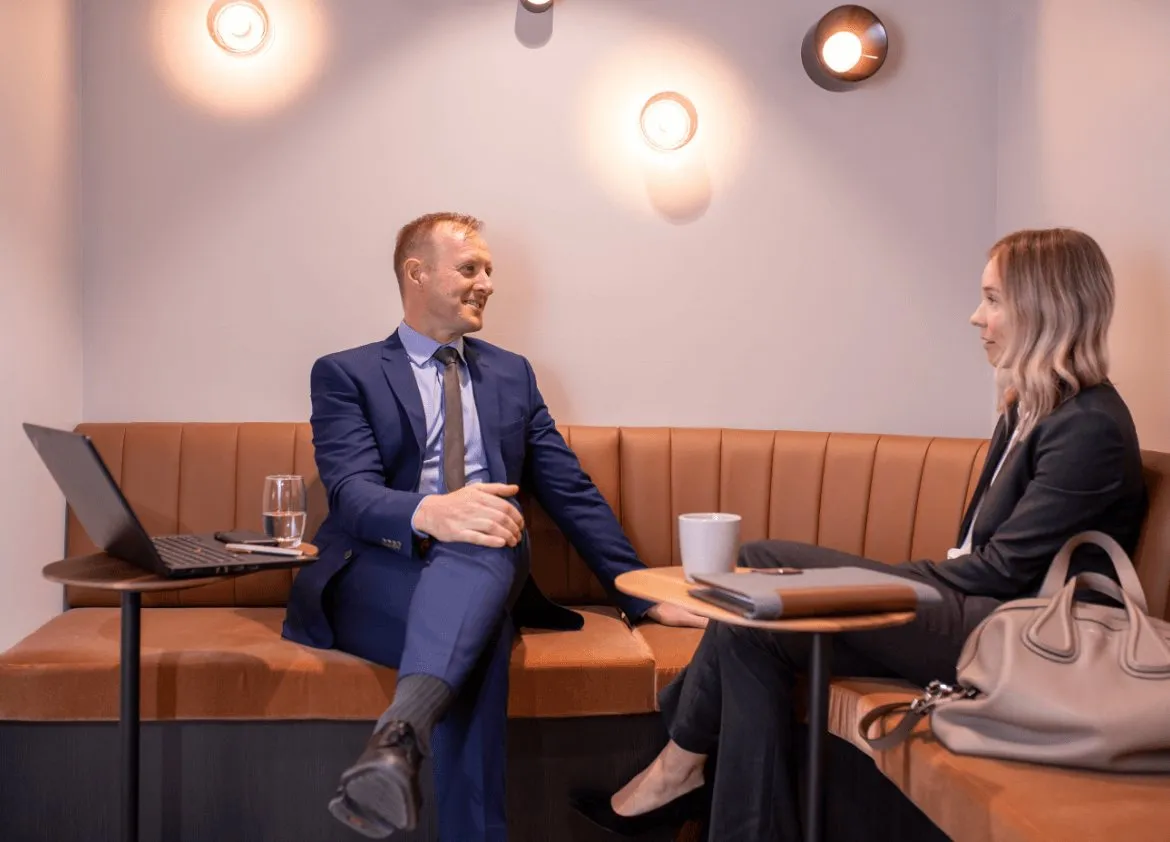 Valuer meeting with a client on a lounge in a modern office