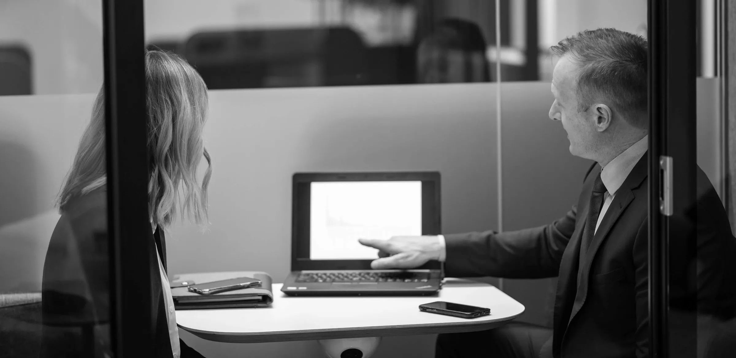 Valuer reviewing an insurance valuation with a client on a laptop